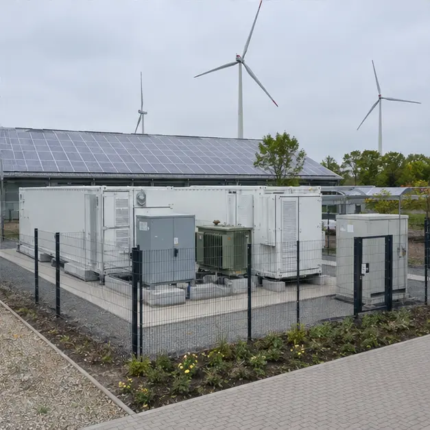 A completed, fenced battery storage installation with the container, power conversion system and transformer visible